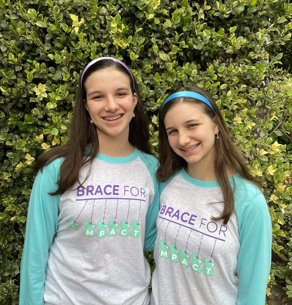 Hadley and Delany wearing Brace for Impact T's