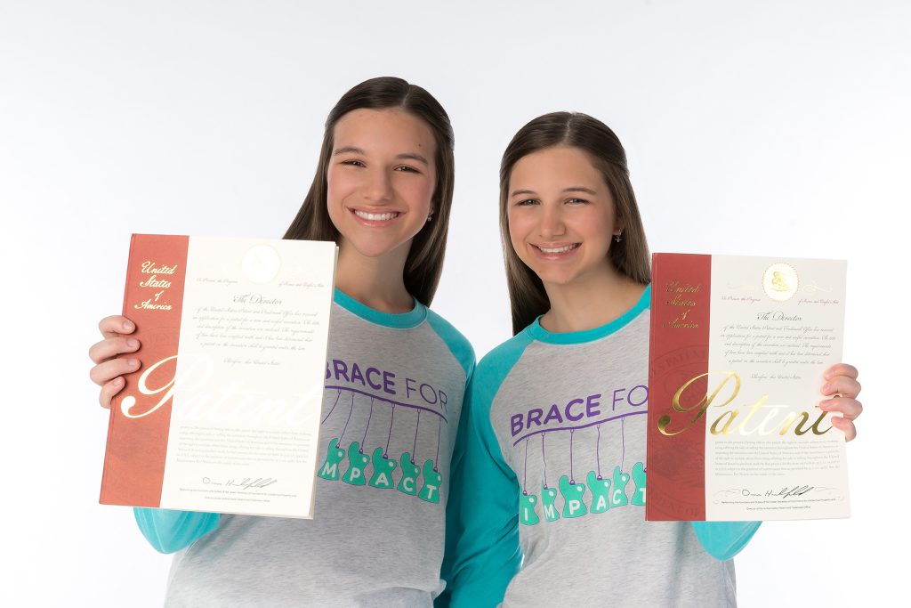 Hadley and Delany hold up their U.S. Patent for BraceTract